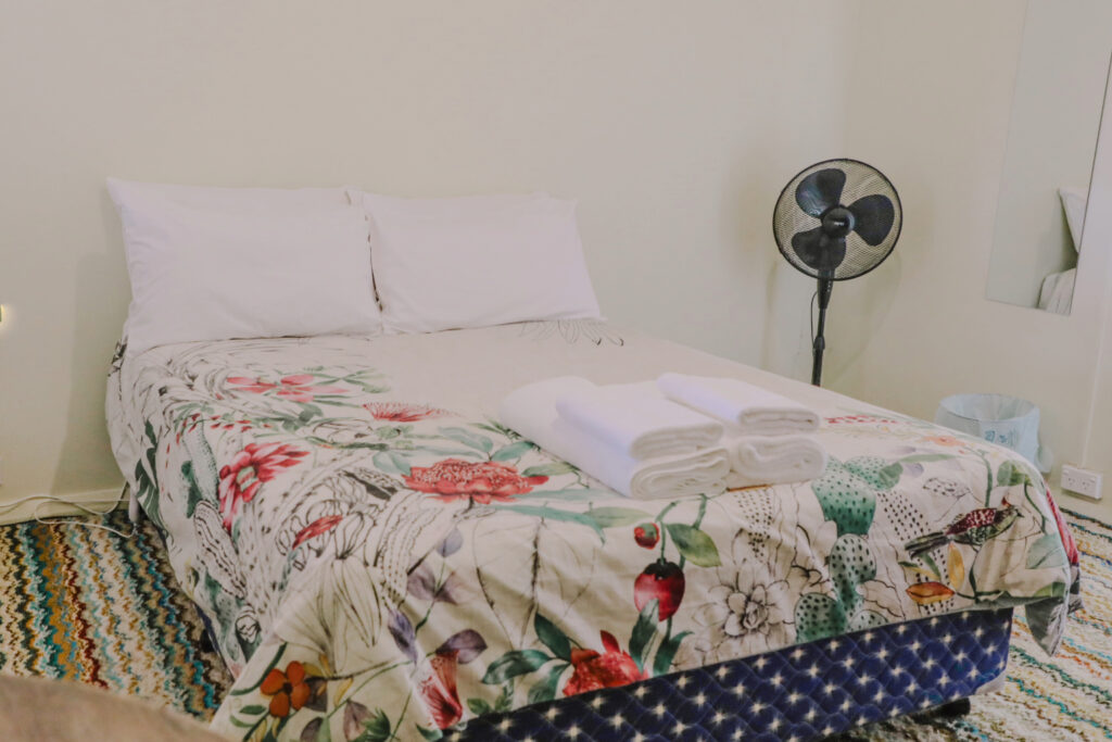 A room with three cozy beds showcasing accommodation options at Royal Capertee Hotel